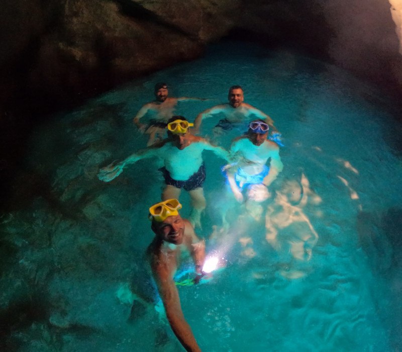 Group snorkeling together inside a sea cave on a Dubrovnik boat tour