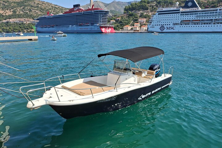 Solitudo private boat moored in Dubrovnik with cruise ships behind